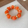 Vintage style orange marbled acrylic bead bracelet with chunky gold metal spacers - Bracelet / Orange Gold