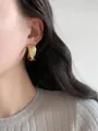 Elegant minimalist chunky gold twisted hoop earrings for women, shown worn by a model - Style 1 / Gold