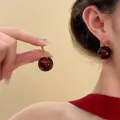 Detail view of vintage dark red spherical earrings worn on the ear for an elegant look - Style 21 Hook Vintage Ball Earrings / Gold-Coffee-Black