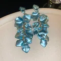 Elegant light blue rose petal tassel drop earrings featuring a luxurious satin metallic finish - Stud Earrings / Blue