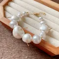 Close-up of elegant French style pearl necklace with cherry shaped bead charms - Bracelet / Gold-White