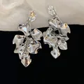 Oversized silver rose petal tassel earrings with high-shine metallic floral finish for women - Stud Earrings / Silver