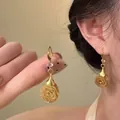 Vintage gold-tone rose drop earrings with textured floral design and crystal accent. - Style 34 Hook Metal Flower Earrings / Gold