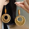 Retro bohemian rattan woven hoop earrings featuring a vibrant orange wood bead accent - Style 42 Hook Bohemian Rattan Earrings / Brown