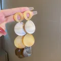 Close-up detail of vintage style yellow and white marbled resin teardrop drop earrings - Marble Teardrop Pendant (22#) / Gold Brown