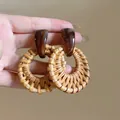Detailed view of vintage style rattan woven hoop earrings with brown resin accent - 10# Silver Earring Post - Brown