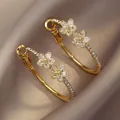 Elegant 18K gold plated flower hoop earrings with sparkling cubic zirconia crystals for women - Gold