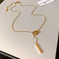 Detail view of gold stainless steel geometric square long necklace with bar pendant - Gold