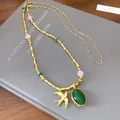 Collana con ciondolo a forma di rondine oro vintage con pietra verde e perline - Rondine Stile Gemma Verde / Oro