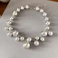Macro detail view of a chunky silver ball necklace featuring irregular sized beads. - Silver