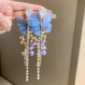 Close-up of elegant blue mesh butterfly earrings featuring long crystal tassels and beads - Gold Mesh Butterfly Pearl Tassel