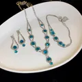 Macro detail of turquoise and rhinestone jewelry set with necklace earrings and bracelet - Necklace Bracelet And Earrings / Three-Piece Set / Silver Blue