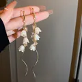 Elegant long tassel drop earrings with white lily of the valley flowers and pink crystals - Gold Lily of the Valley Tassel