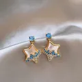 Detailed macro view of gold shell star earrings with blue and white crystals on silk - 3# Gold-Blue