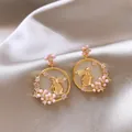 Close-up detail of elegant gold rabbit earrings with pink flowers and crystals - 5# Gold
