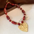 Vintage bohemian red resin beaded necklace with large textured golden heart pendant - Red