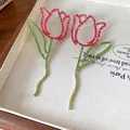 Detailed view of oversized tulip earrings featuring sparkling pink and green rhinestones - Silver Post Hollow Style (WE3746) / Pink and Green