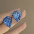 Blue resin geometric stud earrings with silver needles and glittering foil details - Blue