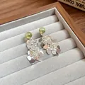 Elegant green bead stud earrings with silver heart leaf tassels in a jewelry box setup - Silver-Green
