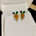 Elegant sparkling carrot shaped stud earrings with orange and green gemstone accents - Gold-Yellow-Green