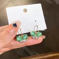 Elegant gold butterfly earrings with green shell wings and sparkly rhinestones - Gold-Green