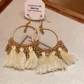 Close-up of Bohemian cream tassel hoop earrings with gold beads and silver 925 tag. - Tassel Ear Hook Style / Gold-White