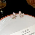 Elegant pink shell butterfly stud earrings with sparkling crystals and gold finish - Gold-Pink