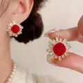 Korean style red zircon stud earrings with gold finish and sunburst crystal halo. - Silver Earring Post-Gold-Red