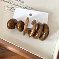 Macro view of vintage brown marbled acrylic C-shape stud earrings on a white jewelry card - C-Shaped Marble Style / 6-Piece Set / Brown