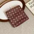 Vintage brown floral print headscarf folded on a wooden tray with a book detail - Dark Coffee Blue White Daisy Style (9#)