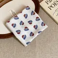 Detailed view of retro floral print cotton bandana folded neatly on a textured linen background - White Base Blue Red Floral Style (6#)