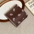 Detailed top-down view of a retro brown paisley print bandana on a wooden tray decor - Coffee White Paisley Style (1#)