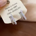 Close-up of elegant double-row clip earrings with pearls and baguette-cut zircons - One Pair / Silver