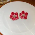 Eleganti orecchini a lobo a fiore rosso con perle e strass su piatto bianco - Fiore con Motivo in Marmo Rosa