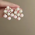 Close-up detail of elegant pink and white pearl flower earrings with a square center zircon - Style 7