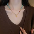 Gold-tone gourd pendant necklace with turquoise beads in elegant New Chinese style. - Blue Bead Chain Style