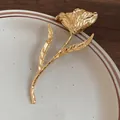 Macro detail of a vintage gold-plated tulip flower brooch with pleated petal texture - Gold Tulip Shape