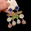 Detailed macro shot of vintage gold earrings with pearls and colorful crystals - Silver Earring Post Style / Blue