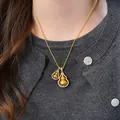 Gold-tone double gourd pendant necklace featuring a sparkling pavé crystal border - Gold Double Pendant Style