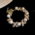 Close-up detail of vintage pearl and rhinestone cross link bracelet in a gold finish - Bracelet / Gold-White