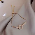 Elegante vergulde titaniumstalen armband met fonkelende in elkaar grijpende zirkonia-ringen. - 15# Ronde Gesp (Echt Goud Verguld)