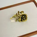 Detailed macro view of an elegant vintage golden rose ring on a textured display board - Gold