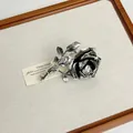 Macro view showing intricate details of vintage silver rose ring with antiqued finish - Silver