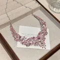 Detailed macro view of vintage pink teardrop rhinestone necklace with silver chain - Silver-Pink