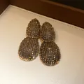 Macro view of golden zircon earrings with intricate pave setting in a jewelry box - 25# Gold Two-Section Teardrop (Steel Post)