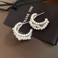 Macro view of elegant silver hoop earrings adorned with white pearls and zircons - Silver Real Gold Plating (8#)