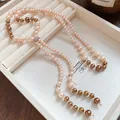 Elegant French style long pearl tassel necklace displayed in a cream jewelry tray - Long Tassel / Champagne