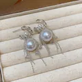 Close-up of elegant silver bowknot pearl earrings with zircon tassels in jewelry box. - Silver White (22#)