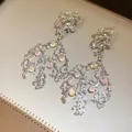 Detailed view of irregular silver-tone dangle earrings with round iridescent crystals - Silver (23#)