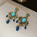 Close-up detail of ornate vintage turquoise earrings featuring gold filigree and blue teardrop beads - Gold Blue (25#)